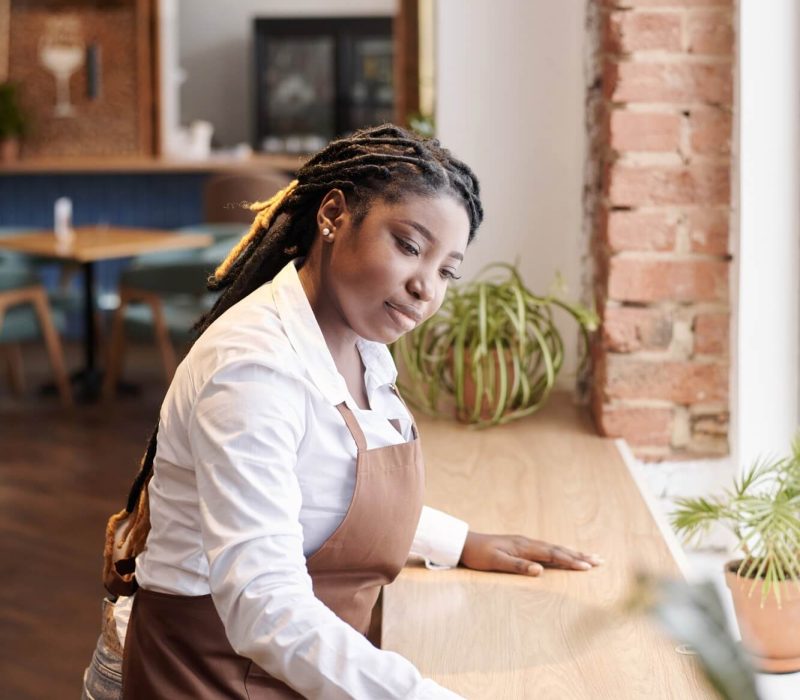young-black-waitress-cleaning-table.jpg